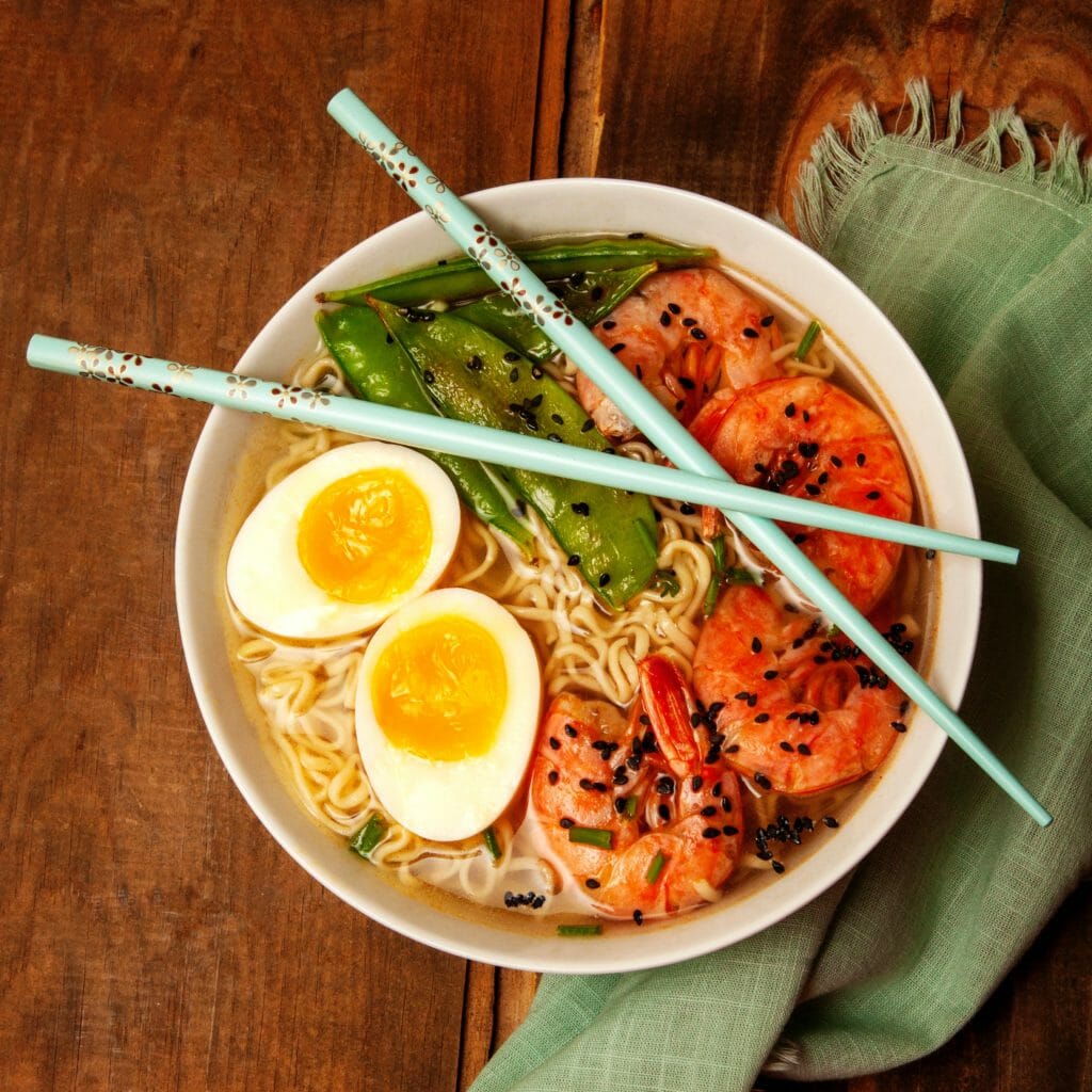 Ramen noodles with soft boiled egg, shrimp and snow peas.